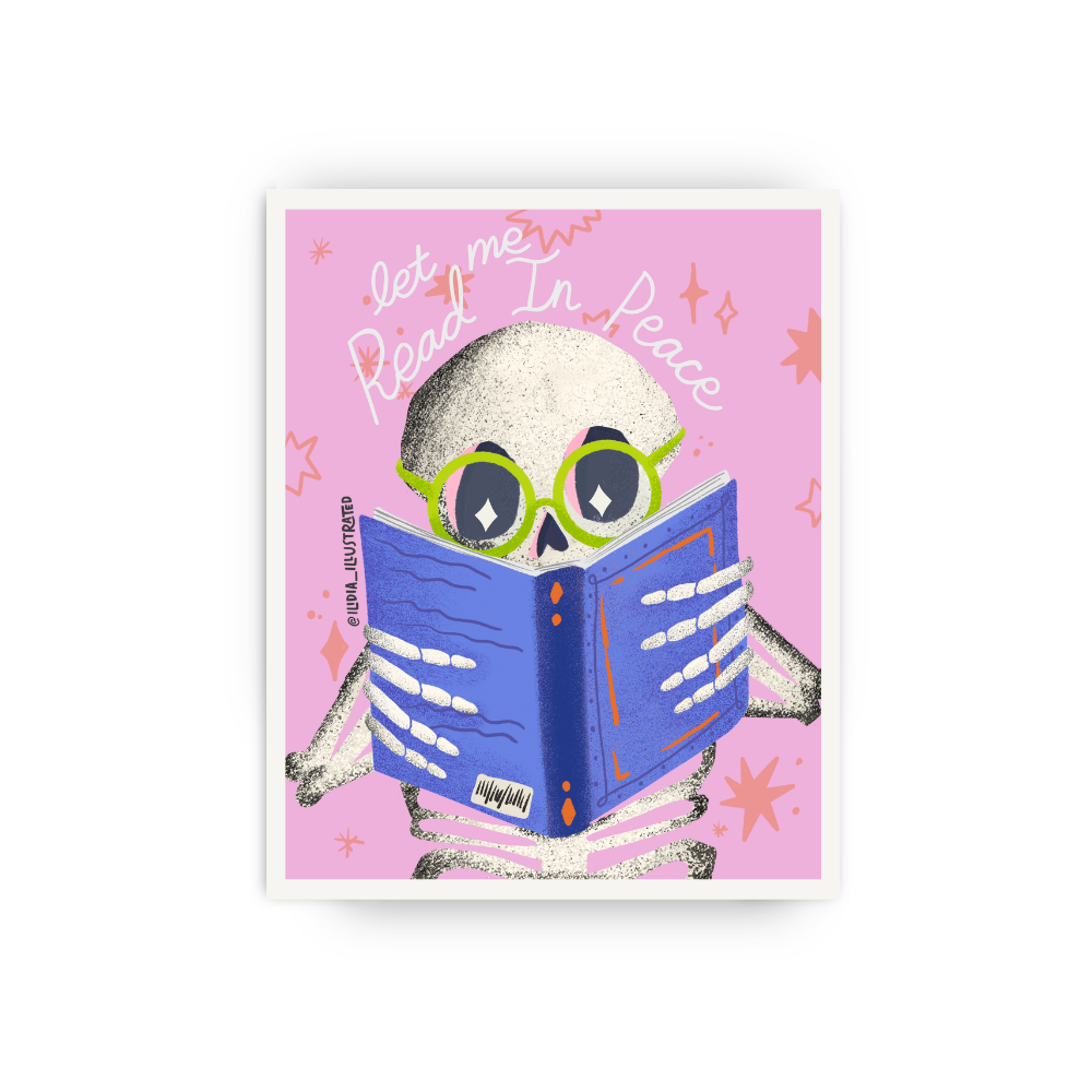A square art print featuring a cartoon skeleton reading a blue book on a pink background with the words 'let me Read In Peace.' The print is shown centered against a light gray studio background.