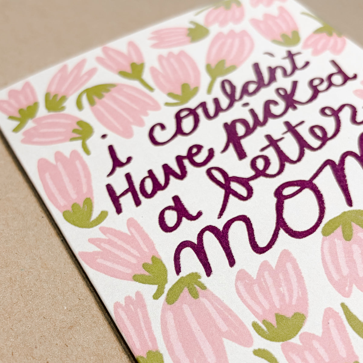 Greeting card with pink floral design and text on a beige background