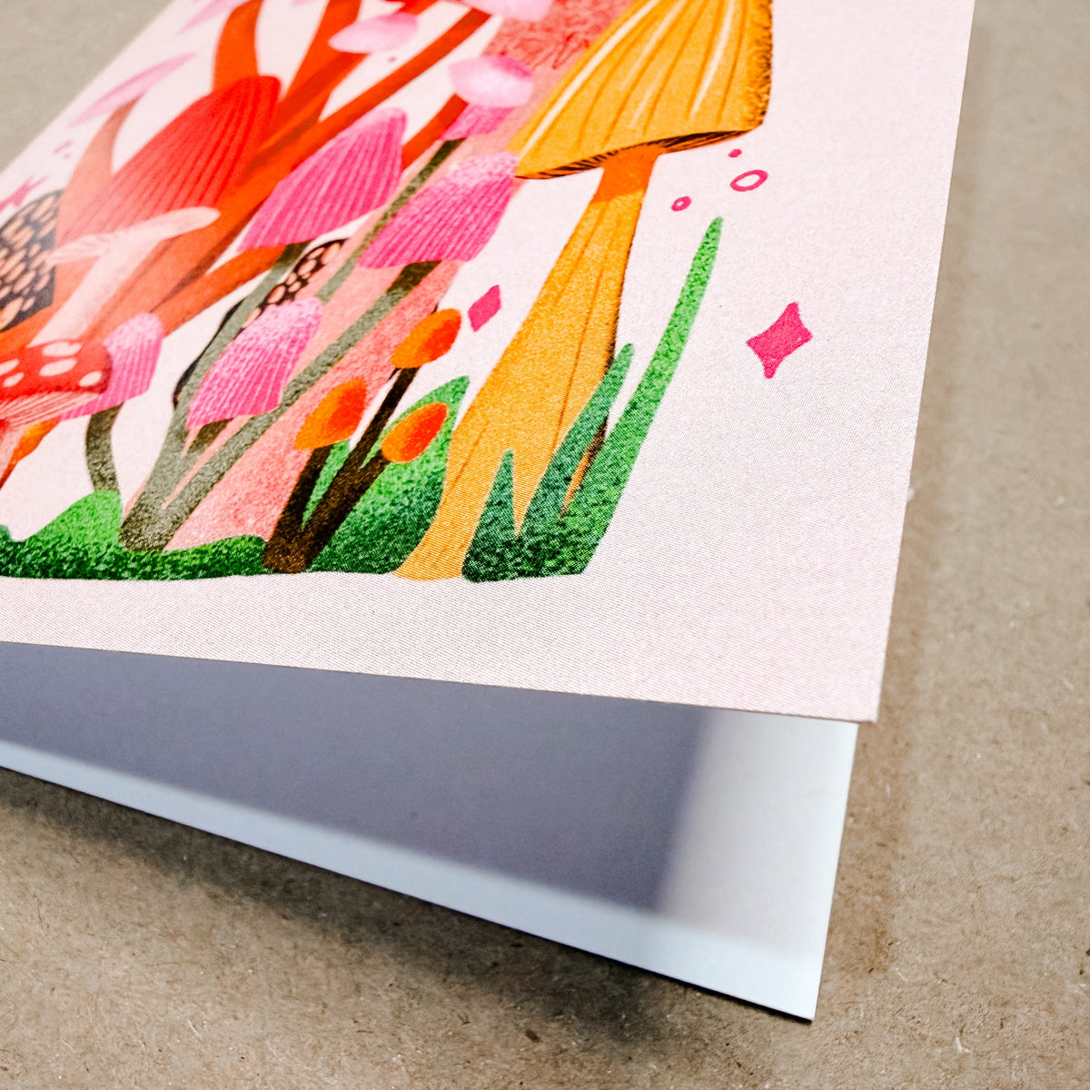 Colorful illustration of mushrooms on a textured brown surface