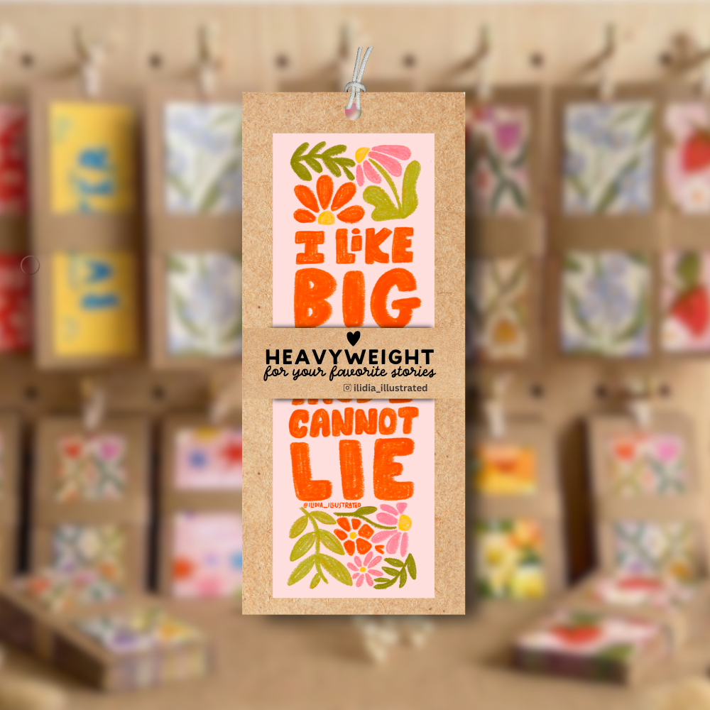 Decorative paper tag with colorful text and floral designs on a blurred background of similar tags.