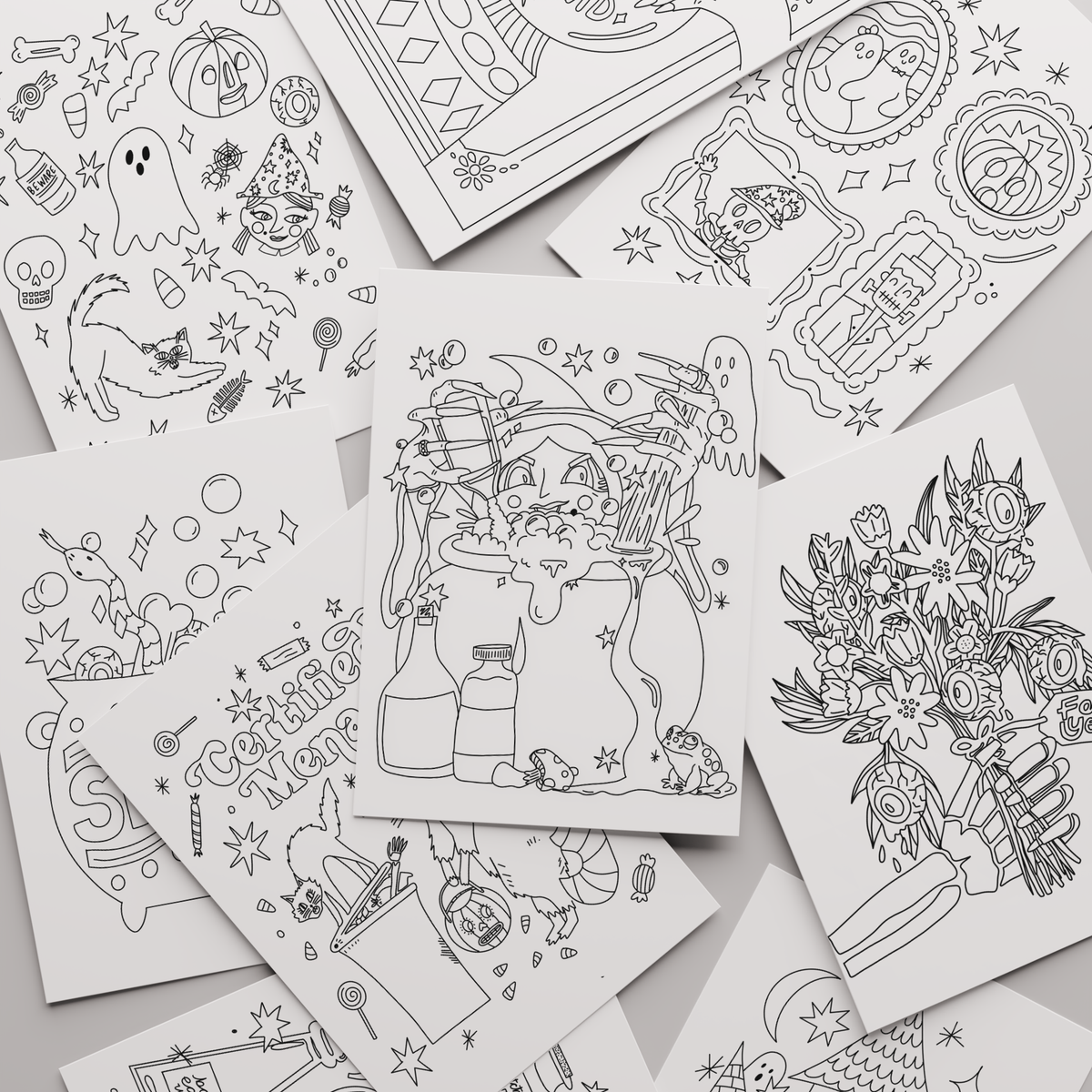 A flat-lay arrangement of multiple white coloring pages featuring black line art illustrations of Halloween-themed characters, ghosts, pumpkins, flowers, and decorative doodles on a light gray background.