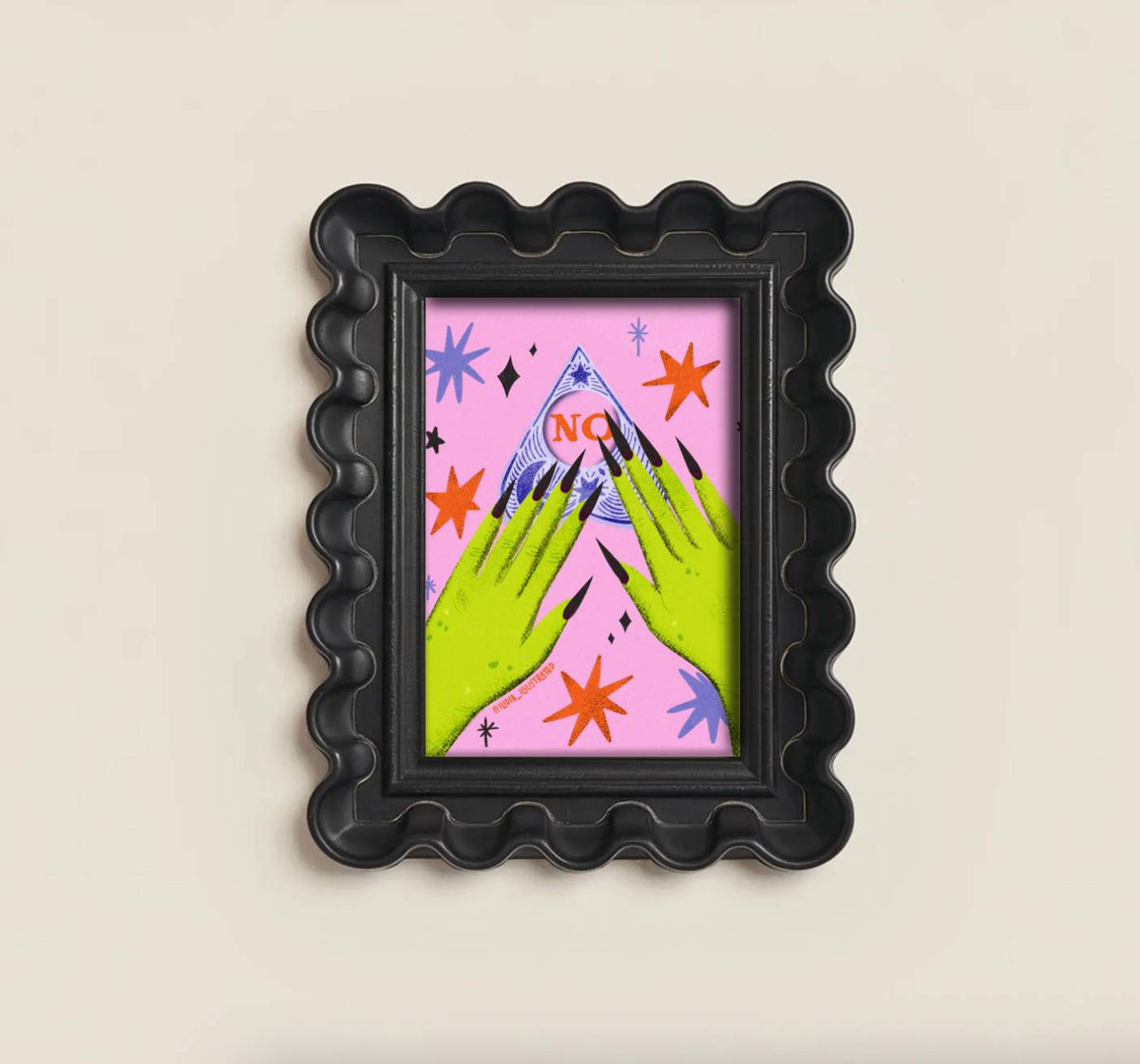 A black scalloped frame holding a colorful art print with two green hands pointing toward a blue mountain under a pink sky with orange stars and the word 'NO' in red.