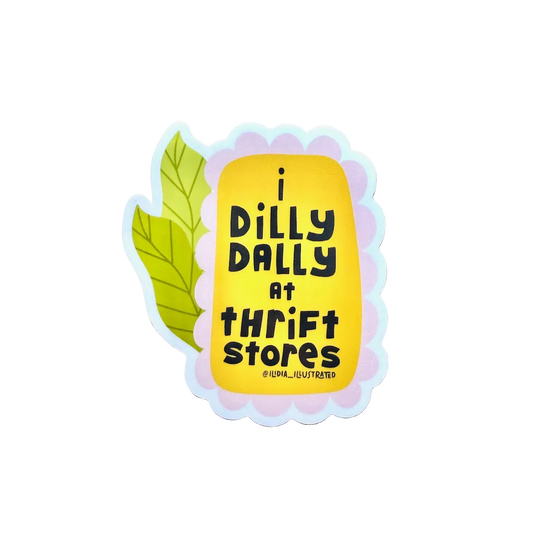 Sticker with text 'i dilly dally at thrift stores' on a wooden surface