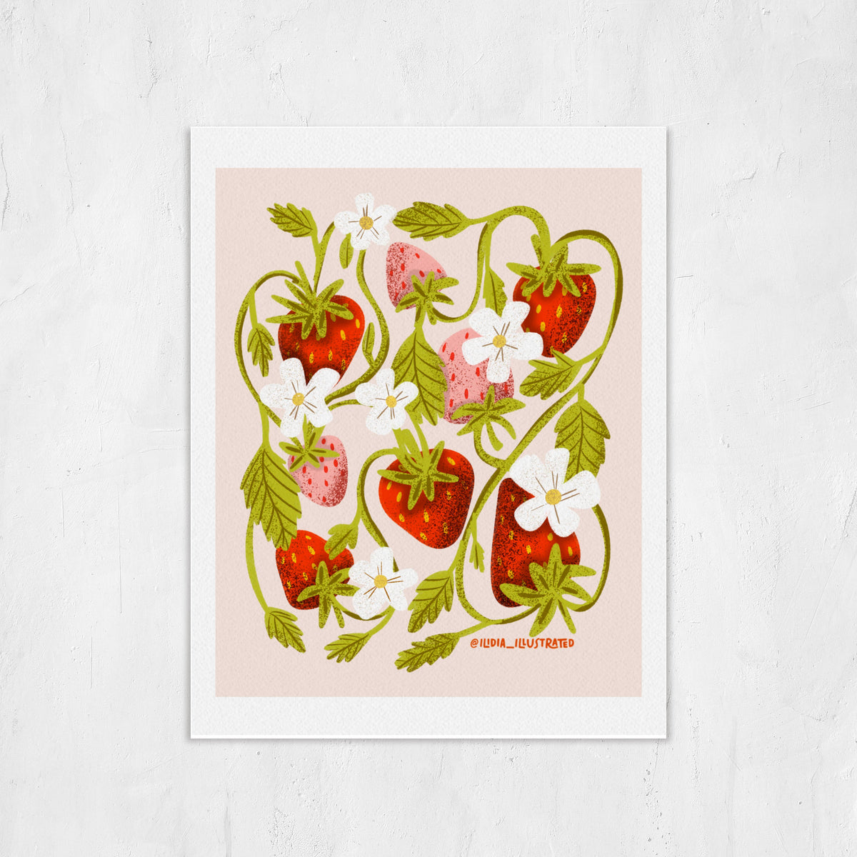 Framed artwork of strawberries and flowers on a light pink background
