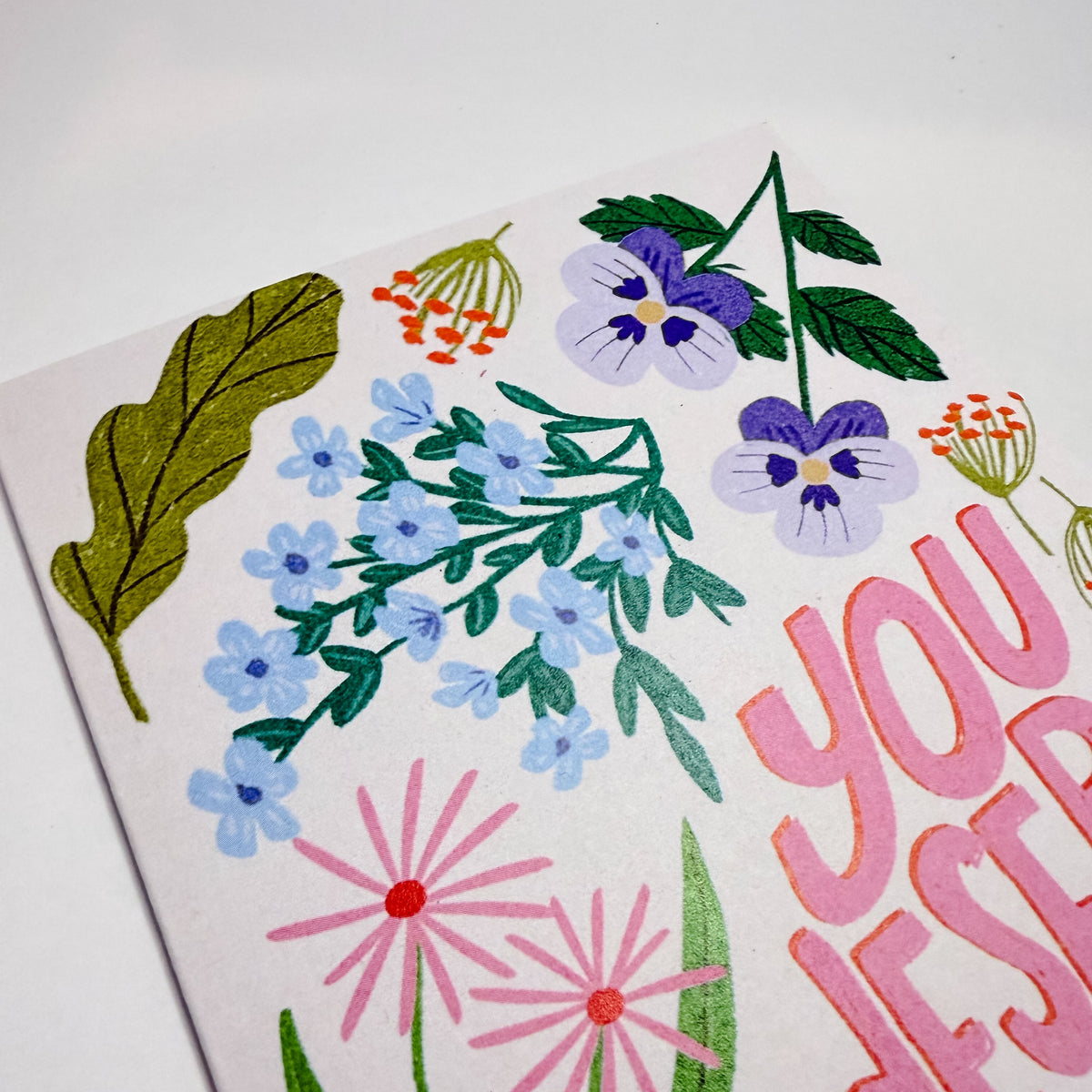 Card with floral designs and text on a white background