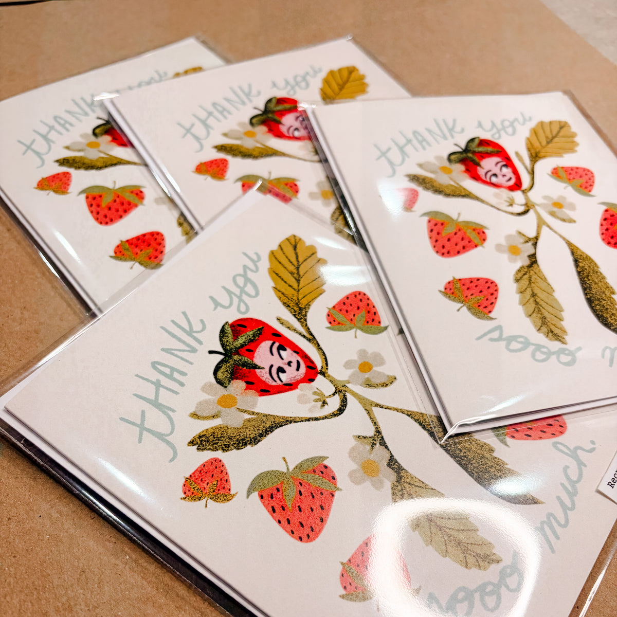 Set of thank you cards greeting cards with strawberry design on a brown surface